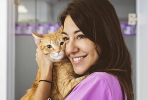 Veterinarian doctor hugging a little cat.